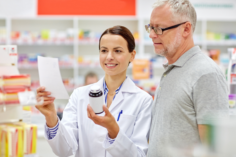 pharmacist and senior man buying drug at pharmacy