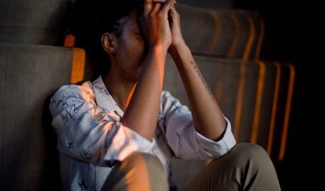 woman sitting against sofa