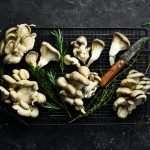 Organic Maitake Mushrooms on the table. on a black stone table. Top view.