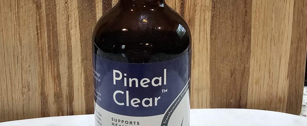 Dropper bottle of Pineal Clear supplement on table.