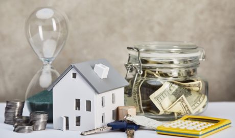 Model house with keys, cash jar, calculator